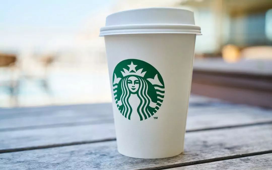 closed white and green starbucks disposable cup
